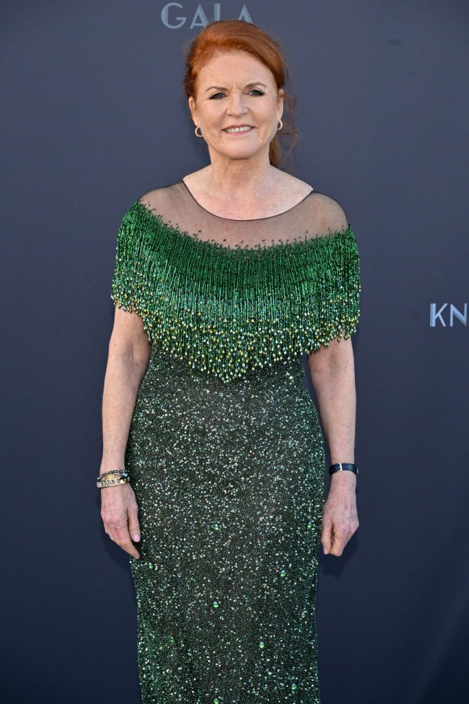 Sarah Ferguson wears an emerald green gown as she poses for photos on a carpet