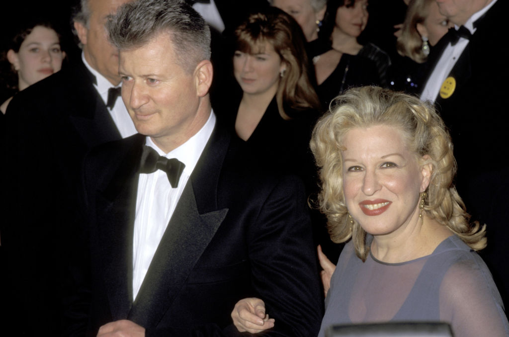 Matthew von Haselberg and Bette Midler smile as they arrive at an event in 1991
