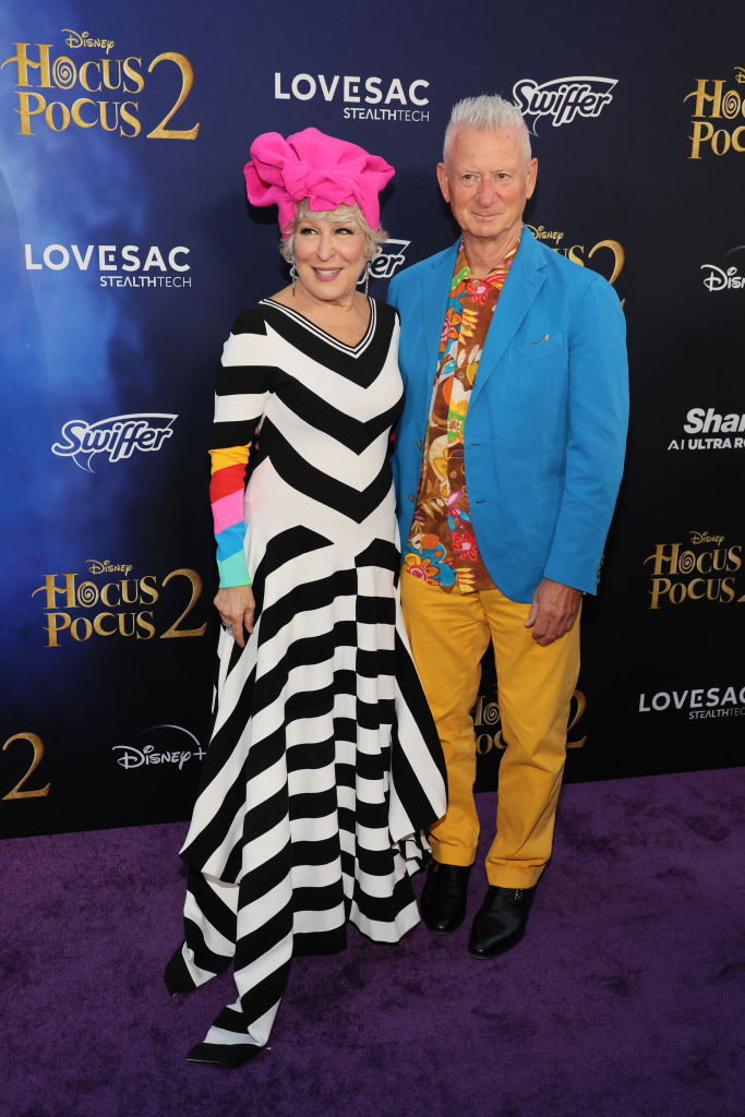 Matthew von Haselberg and Bette Midler smiling with their arms around each other on the red carpet for the Hocus Pocus 2 premiere