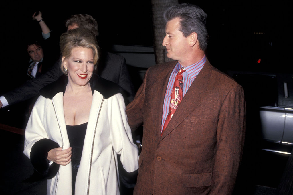 Matthew von Haselberg and Bette Midler smile as they arrive at a film premiere in 1991