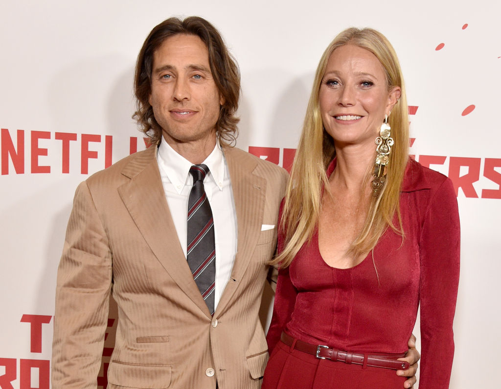 Brad Falchuck and Gwyneth Paltrow with their arms around each other and smiling at a red carpet event