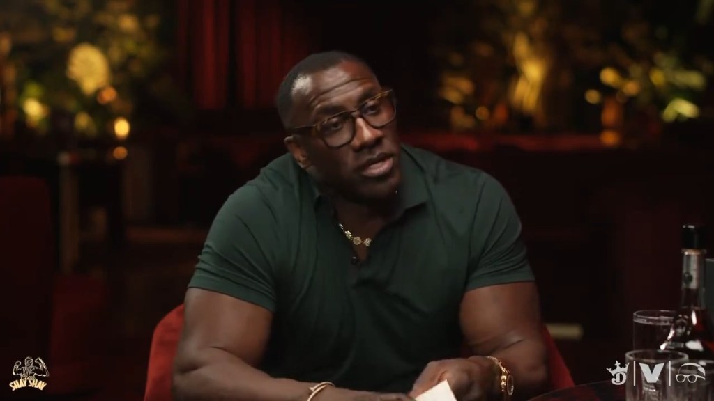 Shannon Sharpe holding a football during an NFL game