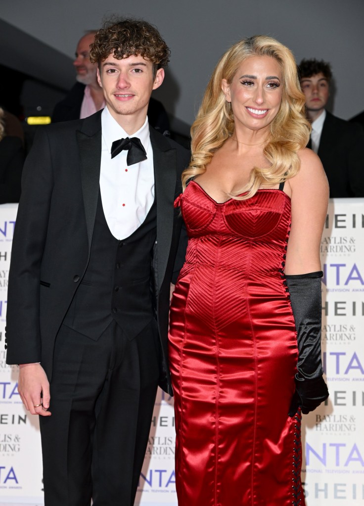 Stacey Solomon poses in a red dress, with her 16 year old son on the red carpet