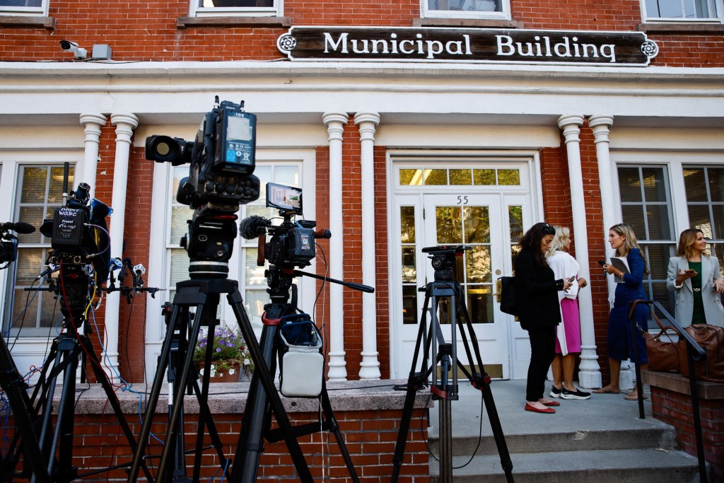 Journalist gathering around the outside of Municipal Building for the arrival of singer Justin Timberlake to appear in court in Sag Harbor. Cameras wait to film his arrival. 