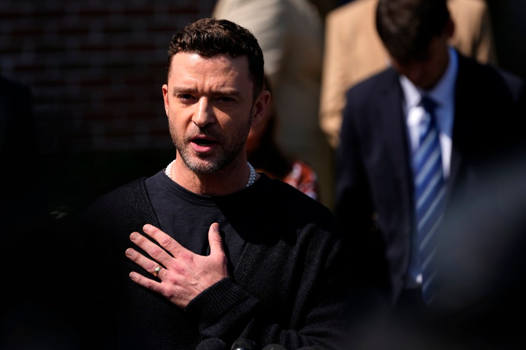 Justin Timberlake speaks to the press after a court hearing with hand on chest 