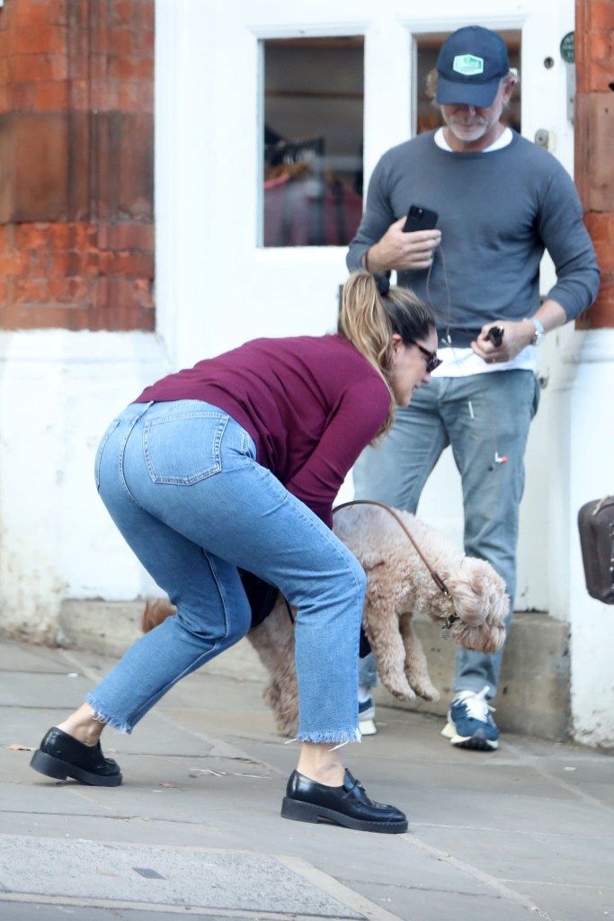 Daniel Craig watches as Kelly Brook picks up her dog