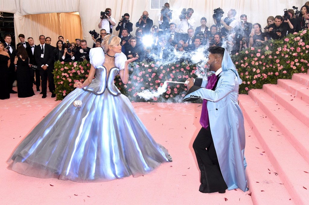 Zendaya and Law Roach showcasing their Cinderella-inspired outfits at the 2019 Met Gala, standing on the pink carpet