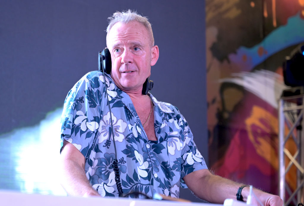 Fatboy Slim DJing in a blue floral print shirt