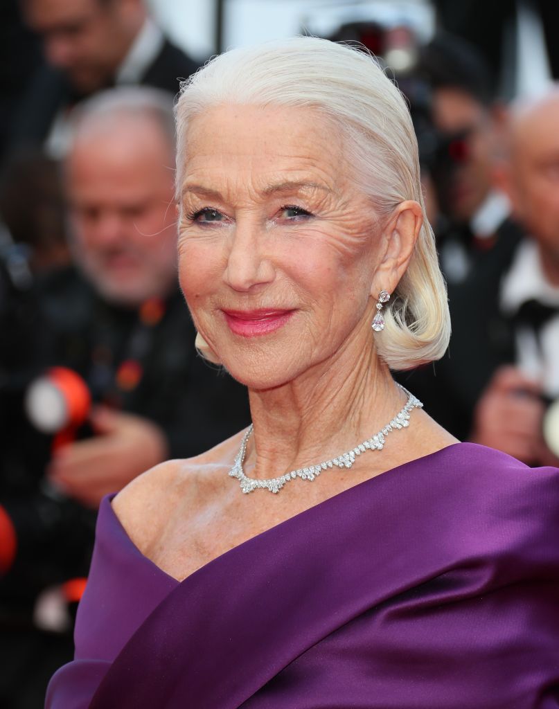 Helen Mirren wearing a purple gown and a diamond necklace at a red carpet event