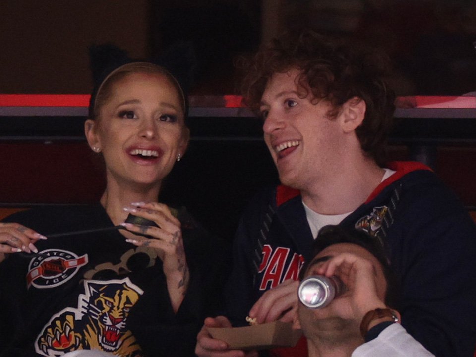 Ariana Grande and Ethan Slater laugh together during an outing