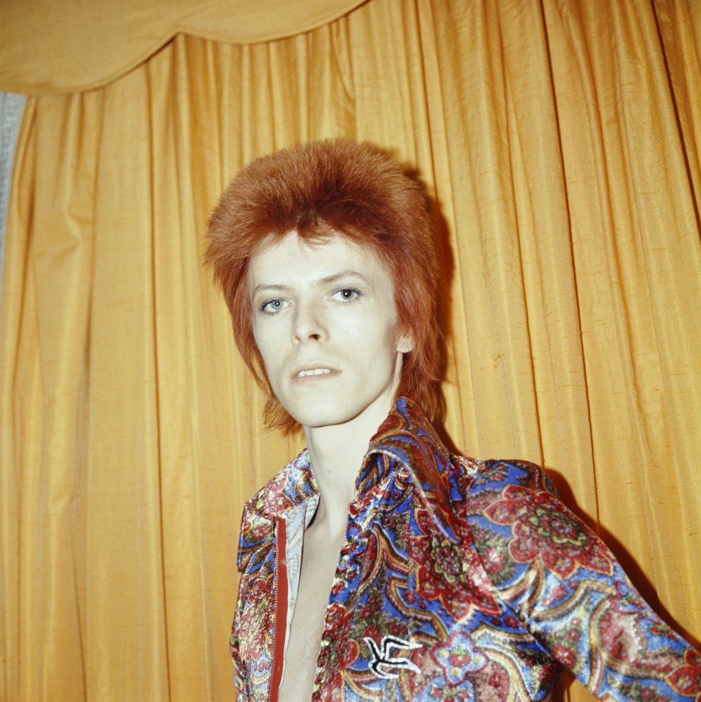 David Bowie with a bright orange mullet hairstyle in the 1970s