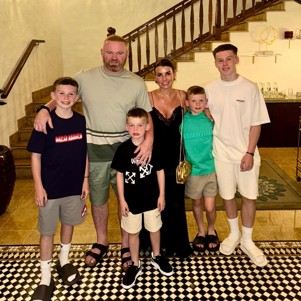 Coleen and Wayne Rooney posing with their children Kai, Klay, Kit and Cass in front of a staircase