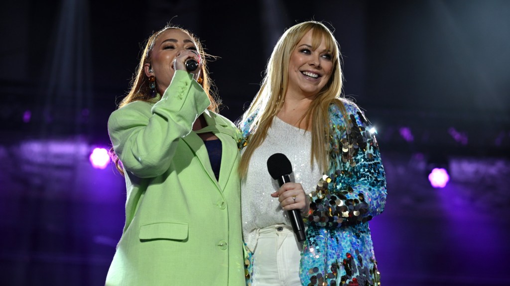 Natasha Hamilton and Liz McClarnon performing on stage as Atomic Kitten