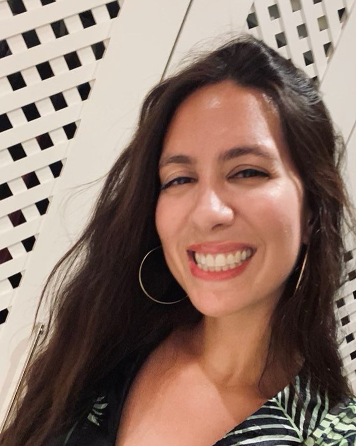 Woman with brown hair smiles for camera