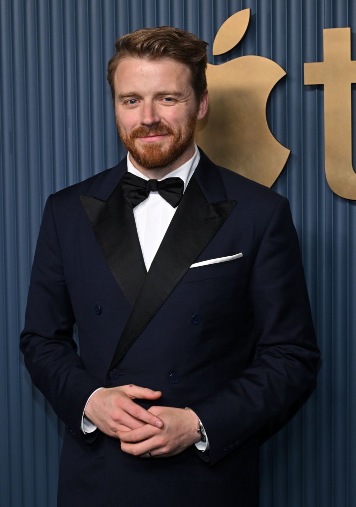 Jack Lowden poses for a photo on a red carpet