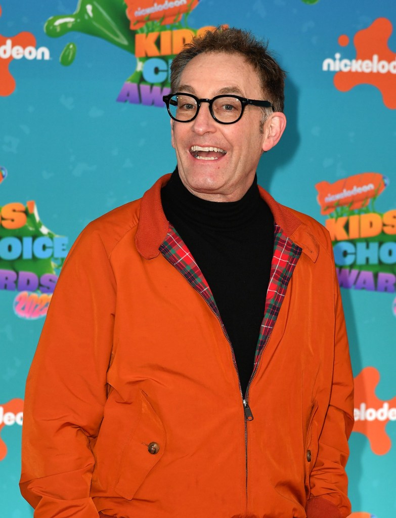 Tom Kenny wears orange jacket on red carpet at the Nickelodeon Kids Choice Awards