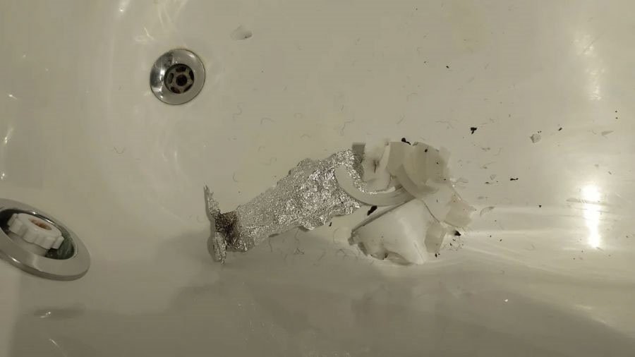 Bath in hotel room with foil crushed up bar of soap