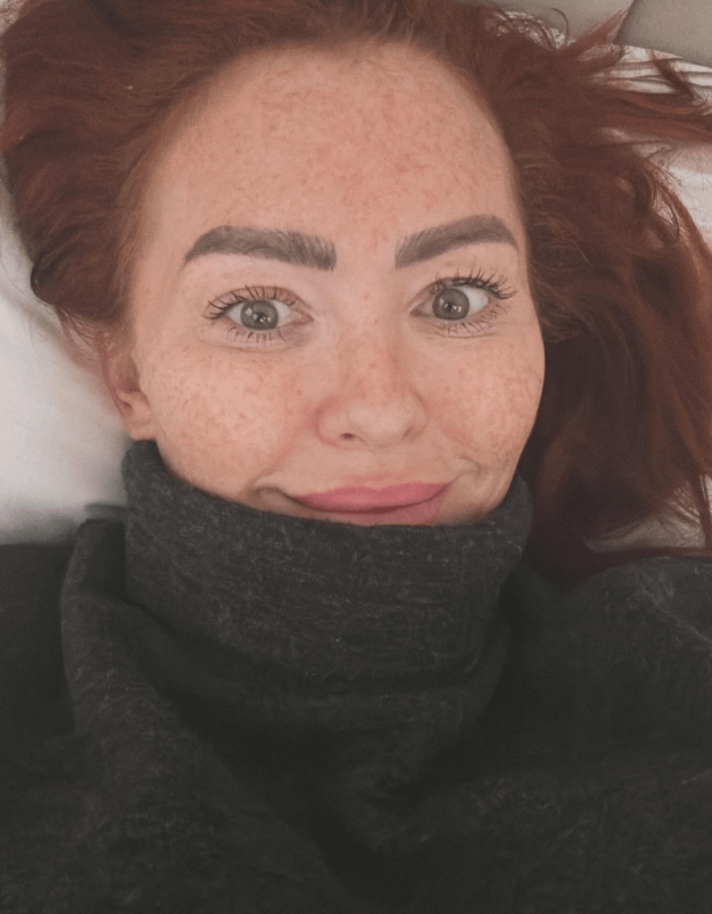 Natasha Hamilton widens her eyes and wears a grey jumper over her chin in a selfie