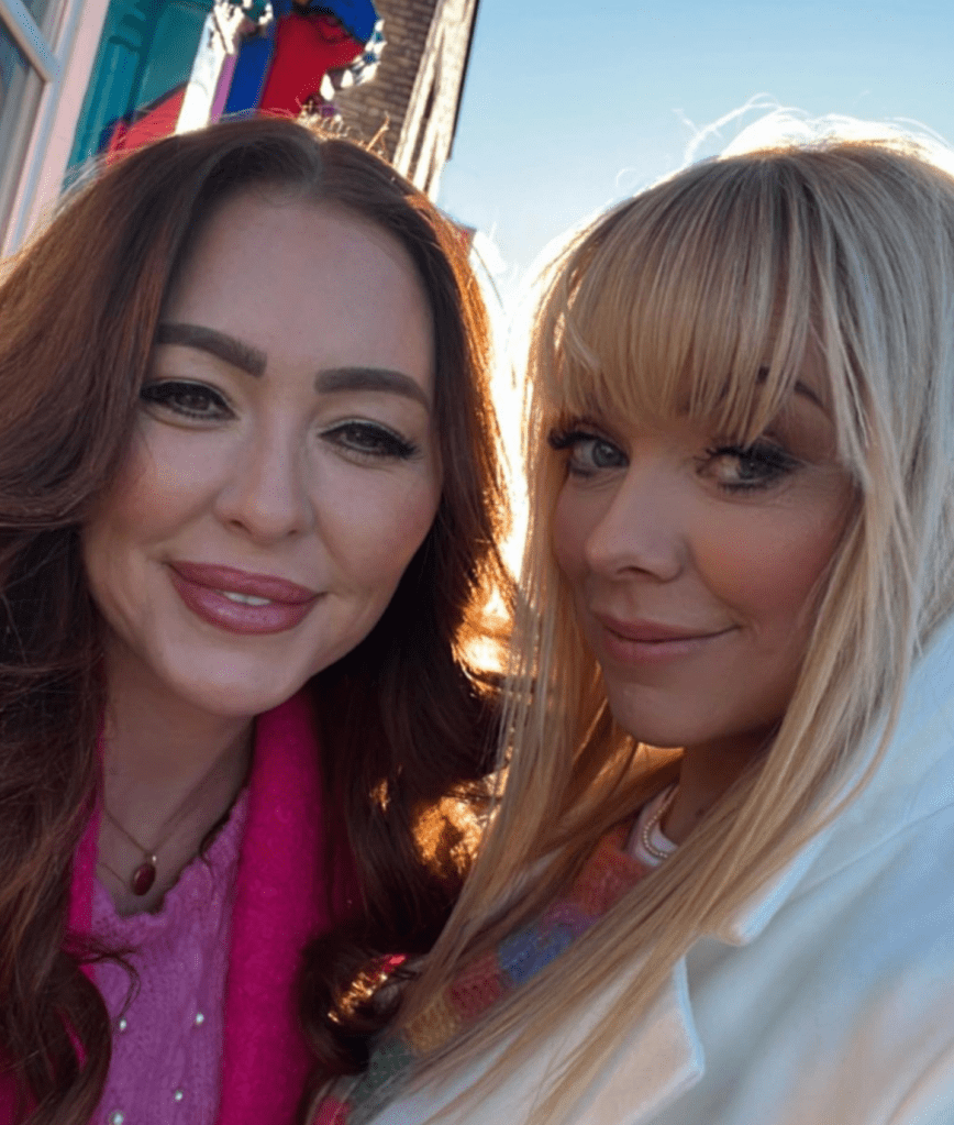 Natasha Hamilton and Liz McClarnon of Atomic Kitten smile for a selfie in 2024